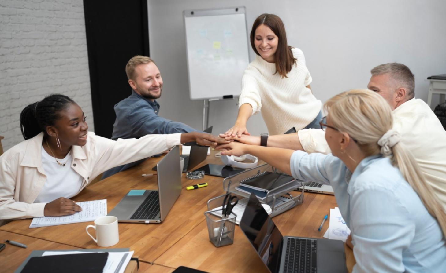 Financial planning workspace with calculator, charts, and budget documents spread across a desk
